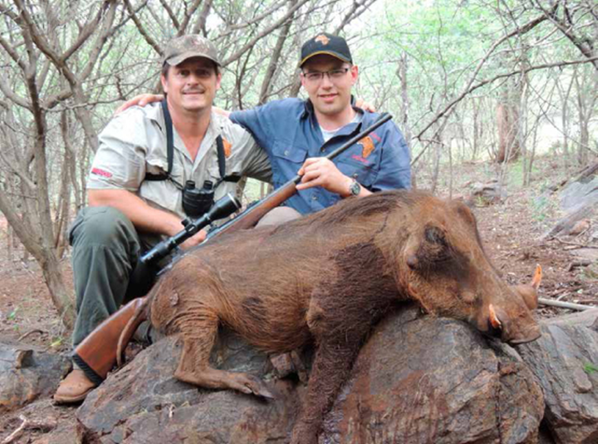 Denis' and the warthog that he took with PH Kobus Vrey.